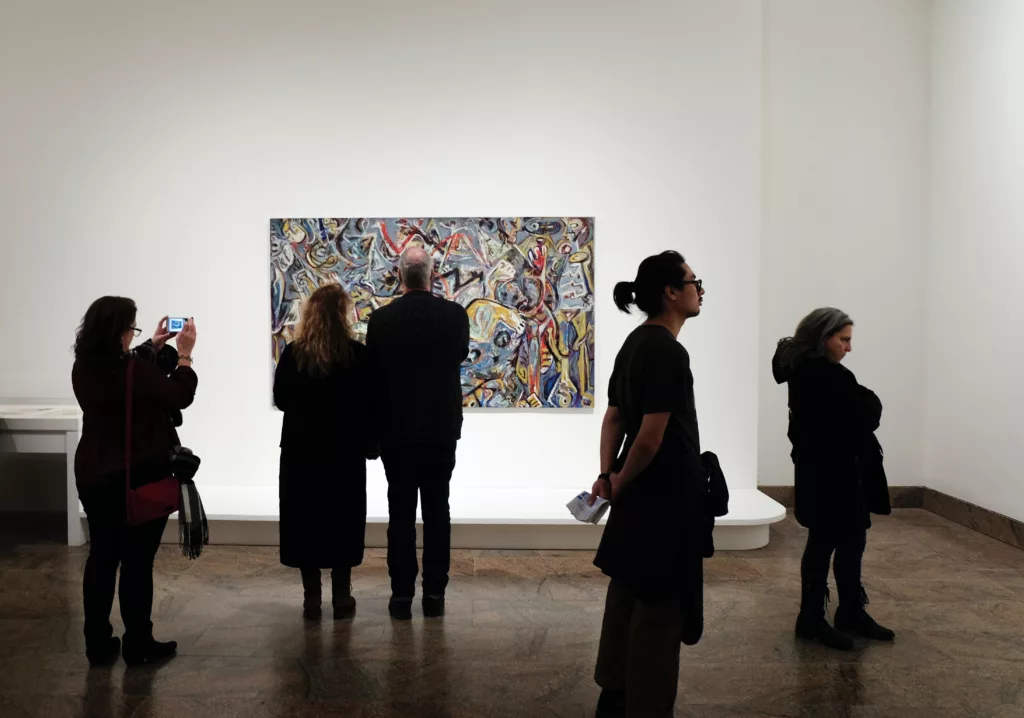 group of people standing in front of unique art at a New York Gallery photo by jessica pamp