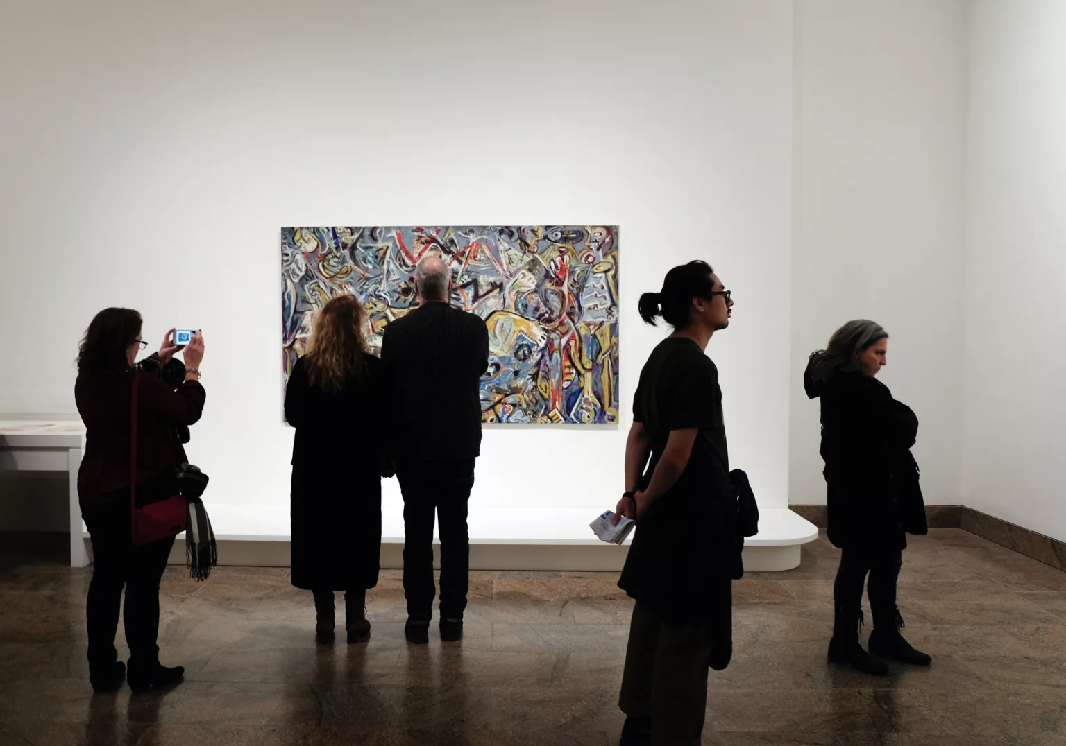 group of people standing in front of unique art at a New York Gallery photo by jessica pamp